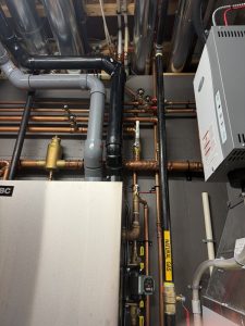Newly installed AprilAire 800 whole-home steam humidifier attached to a furnace in Springbank Hill, Calgary.